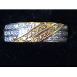 A 9ct gold diamond eternity ring, with twin diagonal bands of stones on three lines of diamonds,