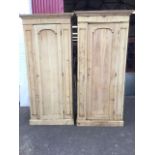 A Victorian pine cupboard and matching wardrobe, with moulded cornices above an arched panelled