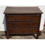 A George VI oak chest of three long drawers with applied bobbin & twisted mouldings, the drawers