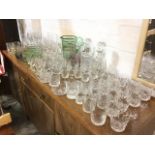 A quantity of drinking glasses including tumblers, wine glasses, brandy balloons, a gilt & green