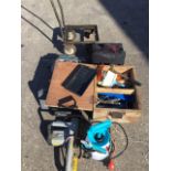 Miscellaneous tools including an electric rip saw, a battery trolley, a sprayer, a chainsaw, a car