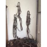 Three equestrian bridles complete with bits and reins - one double bridle with snaffle and French