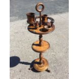 A late nineteenth century mahogany smokers stand, the turned column with ring handle supporting a