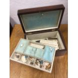 A Victorian rosewood sewing box inlaid with brass banding and mother-of-pearl escutcheon, the fitted