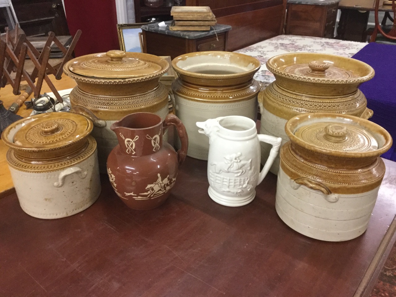 Five salt glazed nineteenth century embossed circular stoneware pots & covers - one minus lid; and