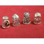 Four novelty silver thimbles - a frog, a puppy, a chinaman and an enamelled cat, all with Sterling