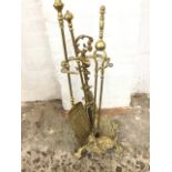 A brass fireside stand cast with rifle & hunting horn above game on naturalistic bowl mounted with