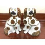 A pair of Victorian Staffordshire wally dogs with copper lustre glazed decoration having yellow