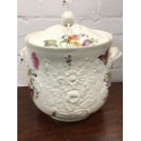 A large bulbous nineteenth century pot & cover embossed in relief with flowers having floral bud