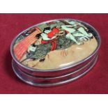 An oval silver pill pot enamelled with an erotic interior scene to hinged lid - 925 marks. (2.25in)