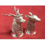 A pair of silver stag & doe salt & pepper pots, cast with tapering necks and circular bases -