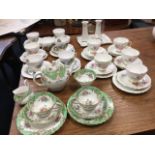 A Tuscan floral tea-for-two set; a Royal Vale teaset decorated with cottage landscapes; a Sheridan