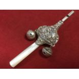 A Victorian style silver babys rattle combined whistle, with tapering mother-of-pearl handle