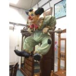 A novelty clown decoration with figure on trapeze.