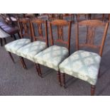 A set of four Victorian rosewood dining chairs, the backs inlaid with foliate scrolled decoration