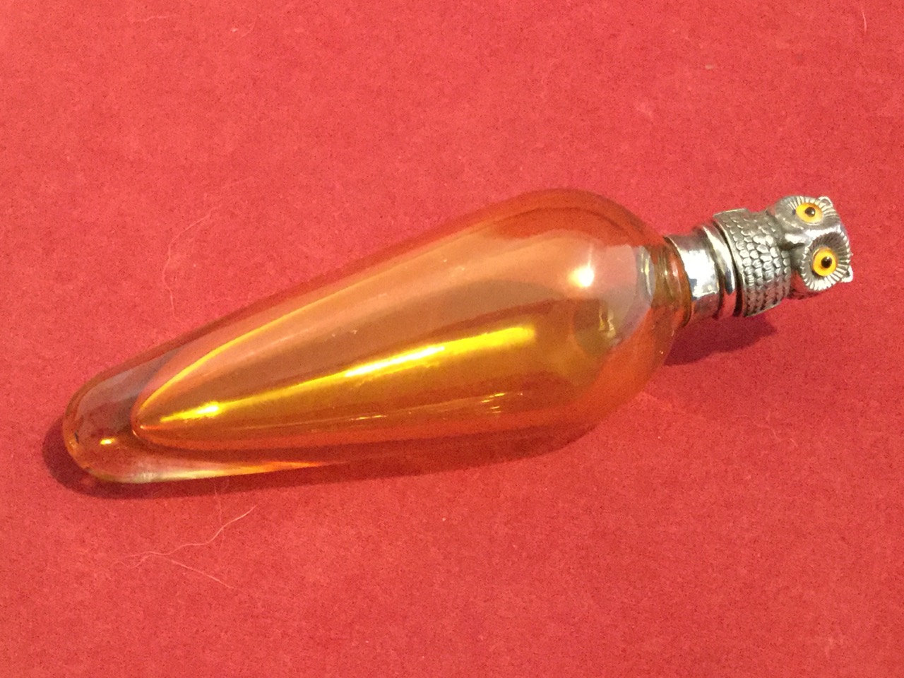A Victorian style amber glass perfume bottle & stopper, the tapering vessel with silver hinged lid