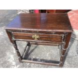 A dowel jointed eighteenth century oak side table, the rectangular moulded top above a fielded panel