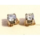 A pair of 18ct gold solitaire diamond stud earrings, the claw set circular stones mounted with