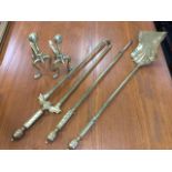 A set of brass fire irons with twisted tubular handles and bobbin finials; together with a pair of