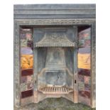 A Victorian cast iron fire insert, the moulded frame with scrolled border, the hood cast with