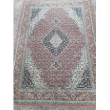 An oriental style Galileo wool rug, the busy pink field woven with scalloped floral medallion and