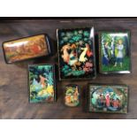 A collection of Russian handpainted and printed rectangular boxes decorated with fairytale scenes on