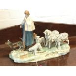 A Royal Dux porcelain group modelled as a shepherd with his sheepdog and flock, on naturalistic