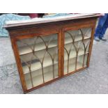 A nineteenth century painted faux rosewood cupboard with moulded cornice above gothic shaped