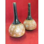 A pair of Royal Doulton stoneware spill vases of onion shape, having embossed and enamelled floral