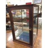 A square Edwardian mahogany counter-top glazed display cabinet, the front with rounded column