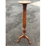 A mahogany jardiniére stand, the circular tray top on a leaf carved twisted and fluted column,