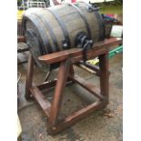 An oak butterchurn on stand, the strapped barrel with cast iron and brass mounts by E Richardson &