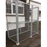 A rectangular galvanised security cage with mesh panels and door, complete with roof, the angle iron