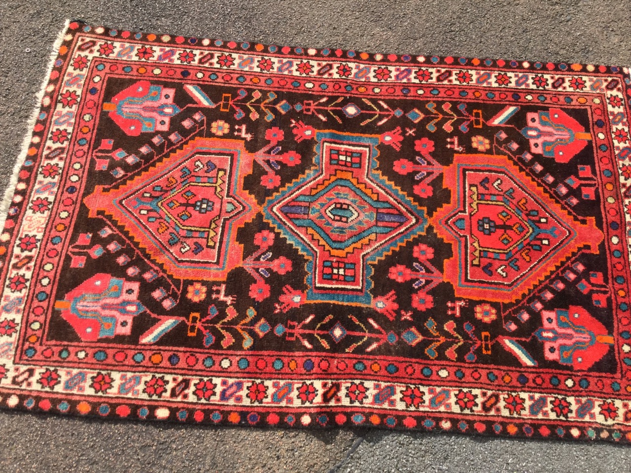 A oriental style wool rug woven with the serrated medallions in brown field with stylised flowers, - Image 2 of 3