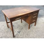 An Abbess oak desk, the rounded rectangular top above a kneehole and pedestal with slide and three