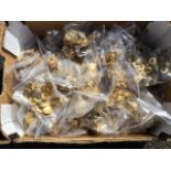 128 bags of miscellaneous brass buttons. (A lot)