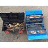 A rectangular concerting style metal tool box containing a quantity of tools - hammers, spanners,