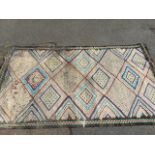 A hand knotted kelim style rug woven with field of lozenges on monochrome ground having turquoise,