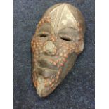An African tribal mask, probably Ghanaian, the adzed carved wood piece with applied composition