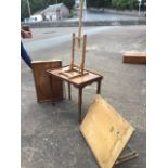 Two tray top tables with folding legs; a beech folding artists easel; and a drawing board on