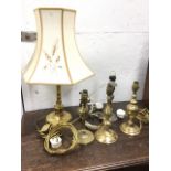 A weighted Edwardian brass tablelamp with swinging mount in scrolled supports, with wall fixing on