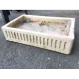 A rectangular salt glazed stoneware trough with ribbed sides. (29.5in)