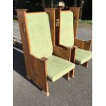 A pair of oak arts & crafts style armchairs, the backs with rectangular window style apertures to