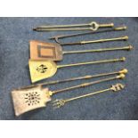 A pair of nineteenth century steel fire irons, the shovel & poker with brass mounts; five other