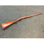 A nineteenth century percussion rifle with hardwood stock and scroll engraved lock, the barrel