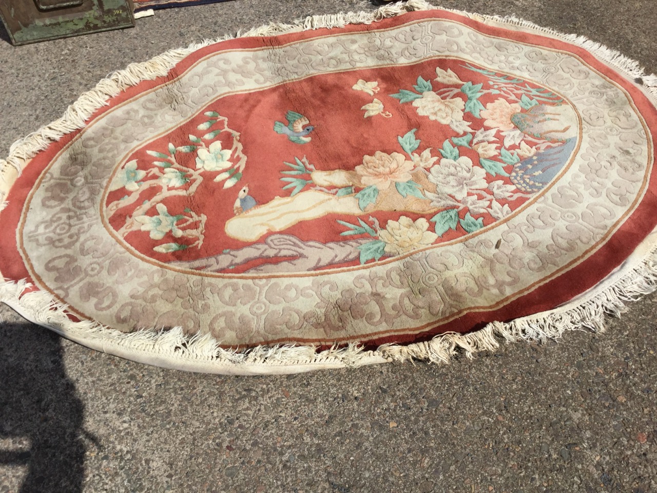 An oval Chinese thick pile wool rug woven with panel of birds, butterflies and foliage on russet - Image 3 of 3