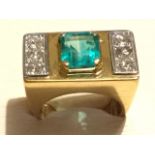 A contemporary 14ct yellow gold emerald & diamond cocktail ring, the rectangular panel claw set with