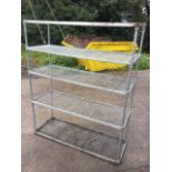 A rectangular aluminium shelving unit with five grill shelves on tubular supports. (60in x 21in x