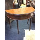 A 'D' shaped mahogany turn-over-top tea table with carved edge above plain frieze, the two back legs