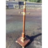 An French Empire mahogany coatstand, the turned column with ormalu tooled urn finial above four pegs